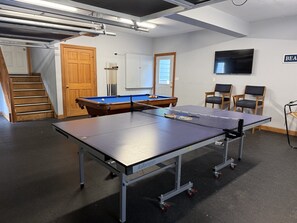 Ein Billardraum mit Billardtisch, Snookertisch und Tischtennisplatte.