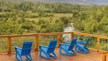 Panoramic deck views overlooking the river and rolling hills—perfect for morning coffee.