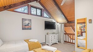A bedroom with two beds, a television, a dresser, and a mirror. - Walk to SKi Slopes  and Hot Tub (Wintergreen Resort)