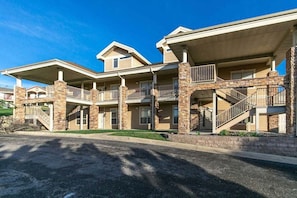 A multi-story hotel with a central courtyard, balconies, and a stone facade. - Table Rock Lake - Emerald Pointe - Walk In Condo w Lake and Pool Access- Free Daily Tickets (Hollister)