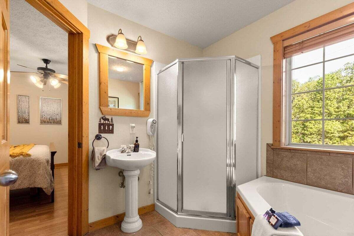 A bathroom with a shower, sink, and bathtub.