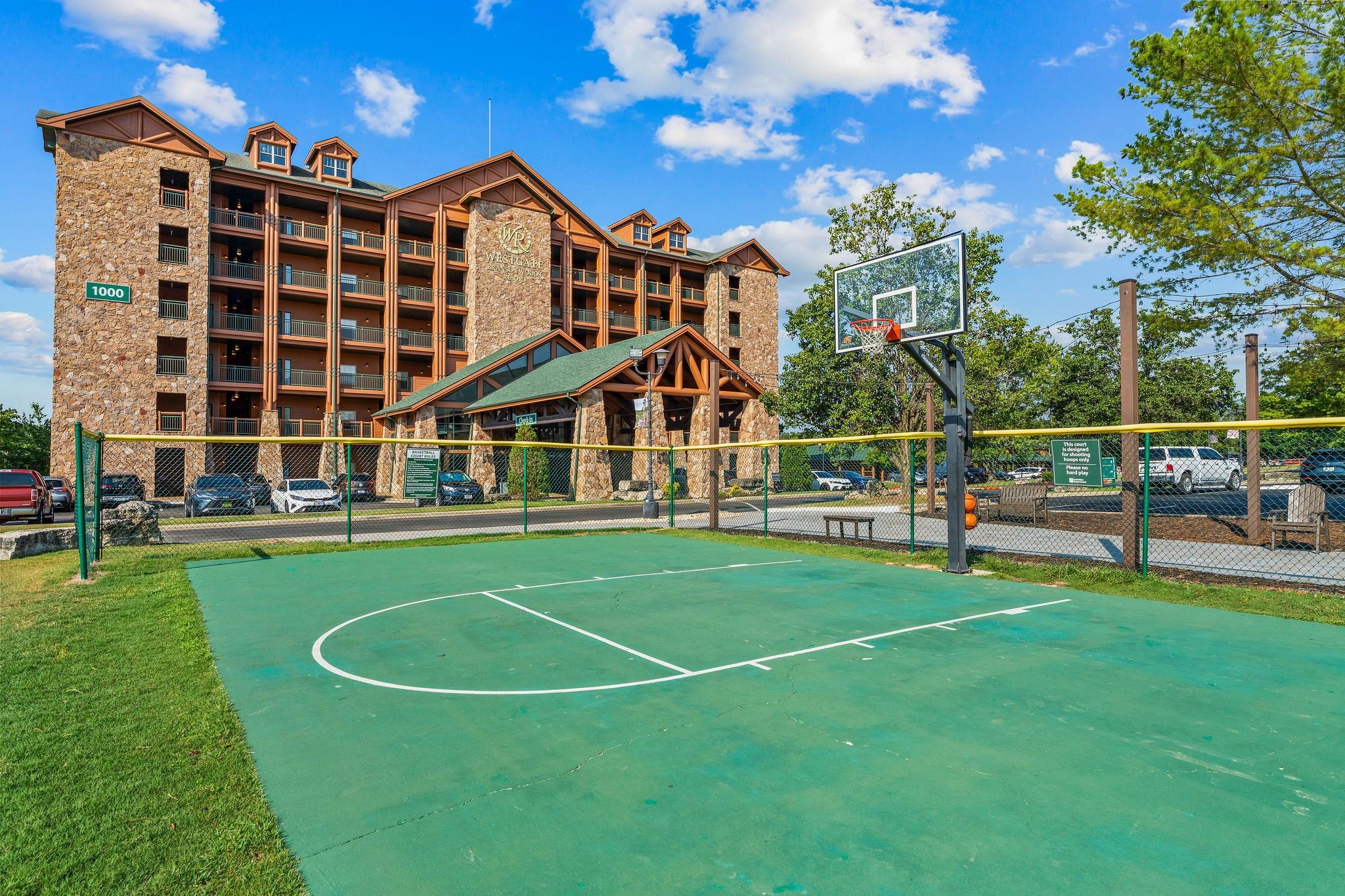 A basketball court with a building in the background.