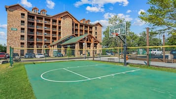 A basketball court with a building in the background.