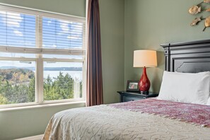 A hotel room with a large window offering a view of a lake and mountains. - Majestic Condo on Table Rock Lake - Views for Mile- Free Daily Attraction Tickets (Branson)