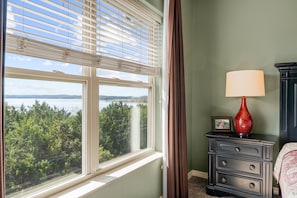 A room with a view of a body of water and trees, a window with blinds, a lamp, and a dresser. - Majestic Condo on Table Rock Lake - Views for Mile- Free Daily Attraction Tickets (Branson)
