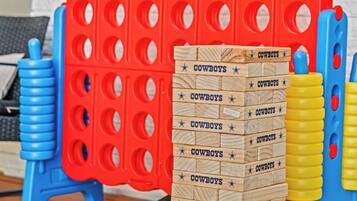 A stack of wooden blocks with 'COWBOYS' written on them, placed on a wooden deck.
