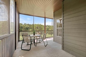 A covered outdoor area with a table and chairs, a view of the outdoors, and a wooden ceiling. - StoneBridge Villa-Near Silver Dollar City-Golf Course Views- Free Daily Attraction Tickets (Branson West)
