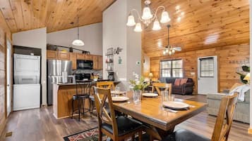 A wooden interior with a kitchen, dining area, and living space.