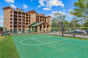 A basketball court with a building in the background.