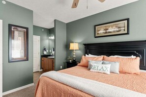 A bedroom with a bed, a nightstand, a lamp, a framed picture on the wall, and a window with blinds. - Great Condo Just 5 Minutes to Branson!- Free Daily Attraction tickets (Branson)