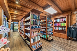 A store with wooden shelves stocked with various items, including hats, socks, and other merchandise.