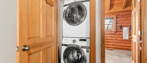 A laundry room with two stacked front-loading washing machines.