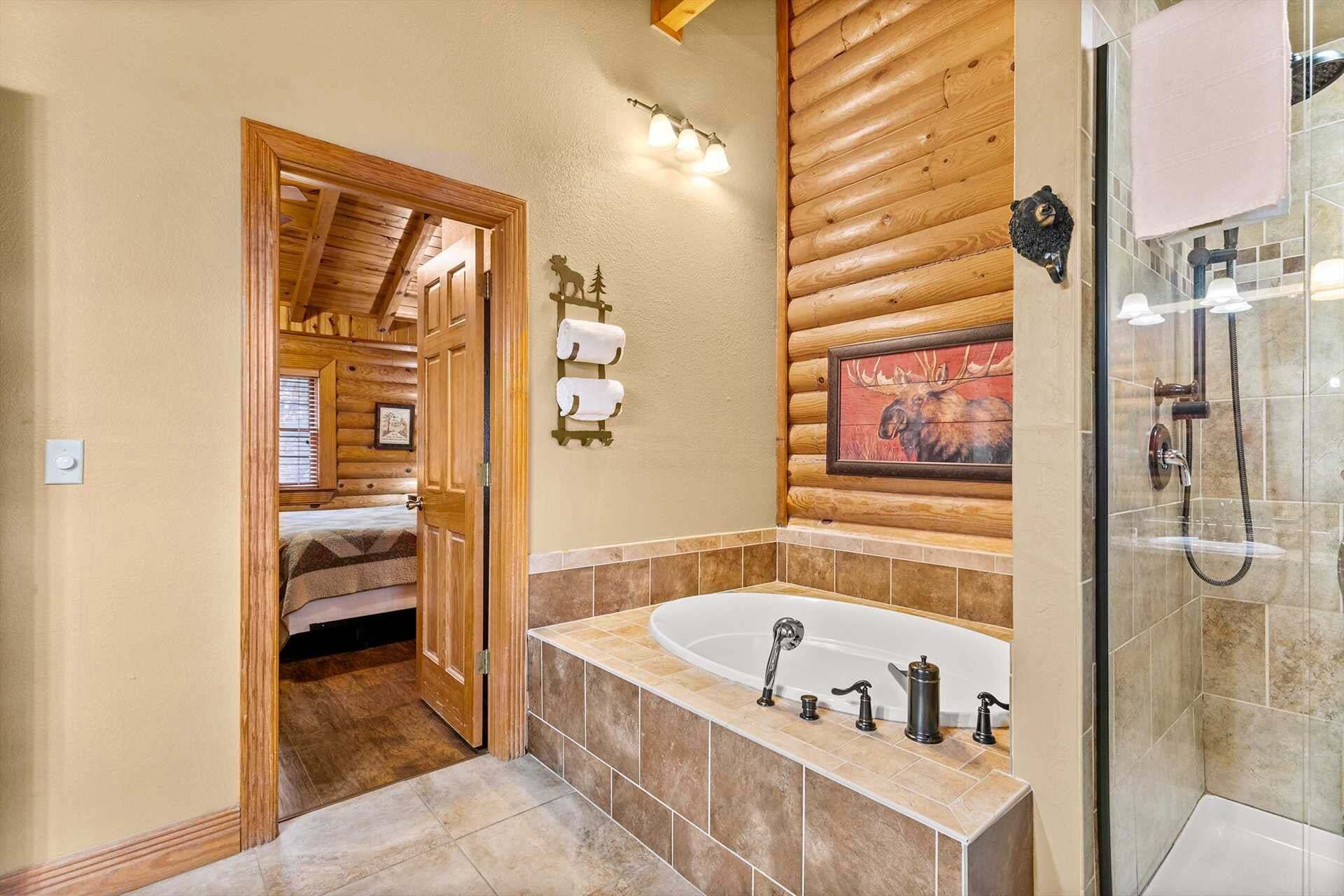 A bathroom with a wooden interior, a large bathtub, a shower area, and a framed animal painting on the wall.