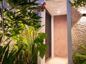 A modern building with a stone wall and a door with horizontal slats. - Private Pool Near Centro, Montejo & Zoo | 2BR (Mérida)