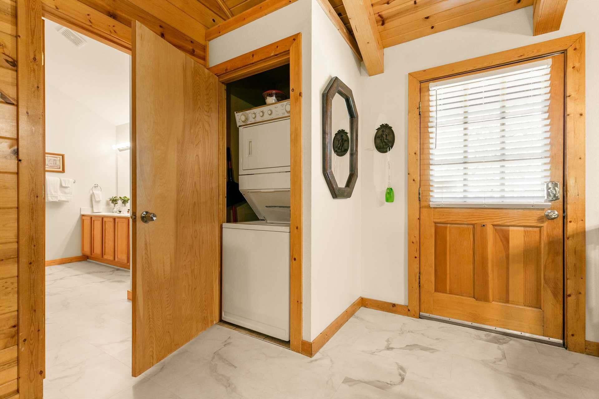 Un intérieur en bois avec une porte donnant sur une buanderie, un miroir et une fenêtre avec des stores.