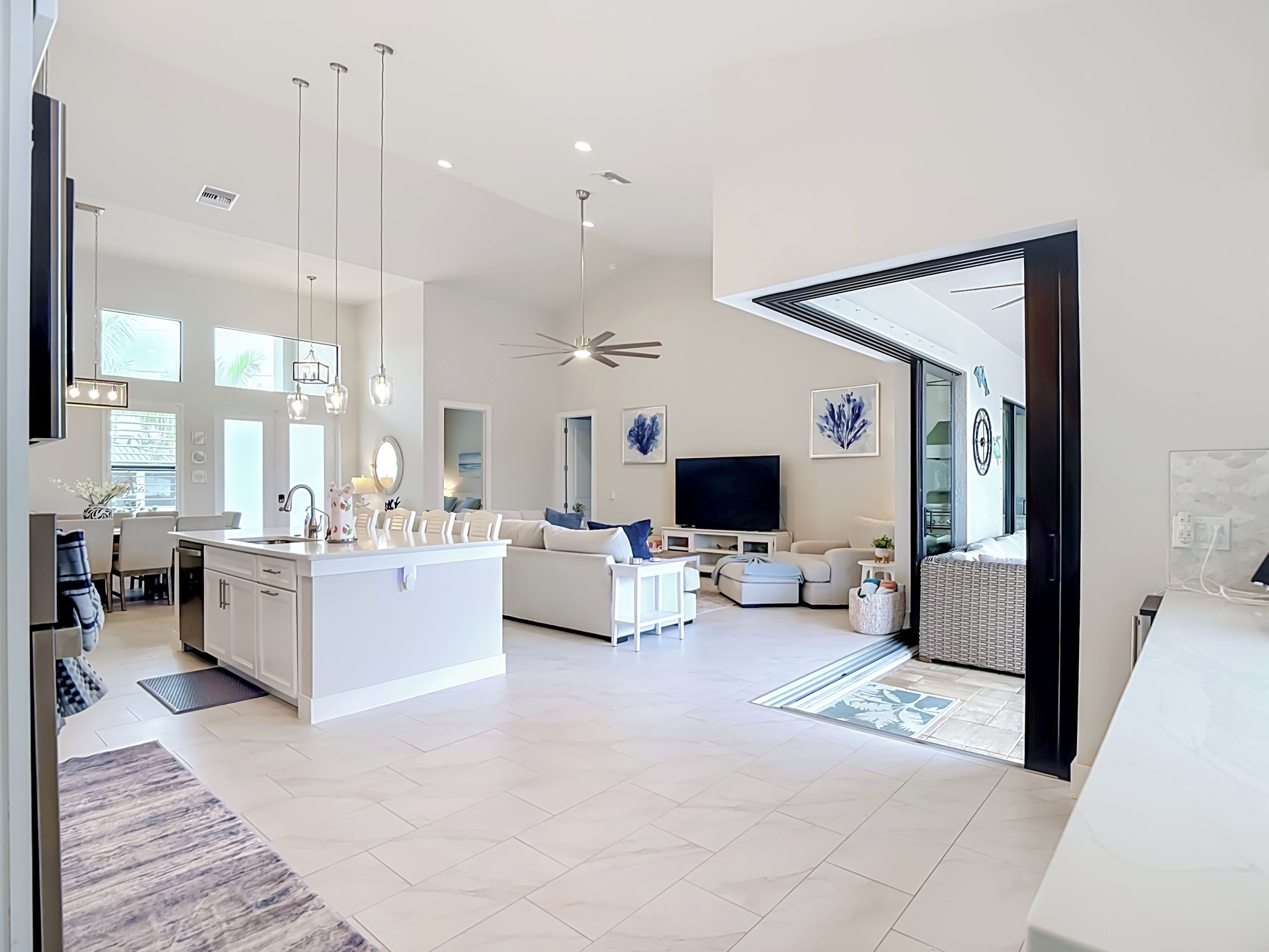 A modern open-plan living space with a kitchen, dining area, and seating area.