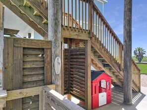 A wooden staircase leading to a red playhouse. - A Sandy Hope Direct Beach Access Sleeps 12 (Bolivar Peninsula)