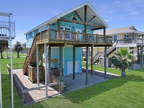 A two-story building with a balcony and a covered outdoor area. - A Sandy Hope Direct Beach Access Sleeps 12 (Bolivar Peninsula)