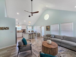 A spacious living area with a high ceiling, a dining area, and a kitchen. - A Sandy Hope Direct Beach Access Sleeps 12 (Bolivar Peninsula)