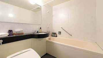 A modern bathroom with a toilet, sink, and bathtub.