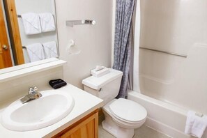 A bathroom with a sink, toilet, and bathtub. - Sugarloaf Mountain Snowbrook Village C2524 (Carrabassett Vly)