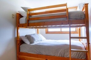 A bunk bed with a ladder, a window, and a wall socket. - Sugarloaf Mountain Gondola VillageC2210 (Carrabassett Vly)