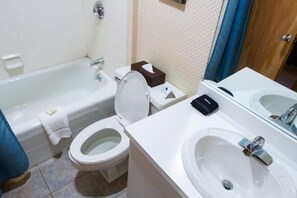 A bathroom with a bathtub, toilet, and sink. - Sugarloaf Mountain Sugartree II C289 (Carrabassett Vly)