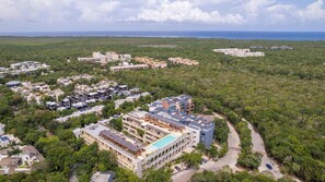 A resort with multiple buildings, a swimming pool, and a road winding through a forested area. - Tulum 2BR Private Plunge Pool 2 King Beds (Tulum)