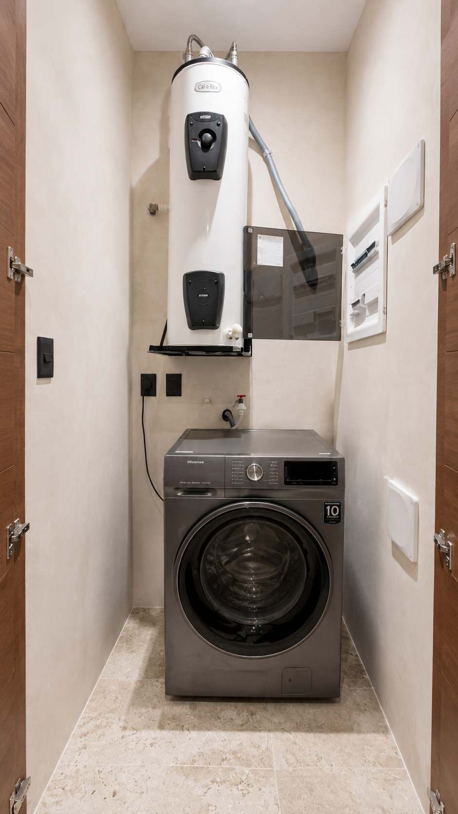A compact laundry room with a front-loading washing machine and a wall-mounted water heater.
