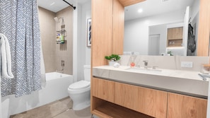 A modern bathroom with a shower, toilet, and vanity. - The Crosby Miami Condos (Miami)