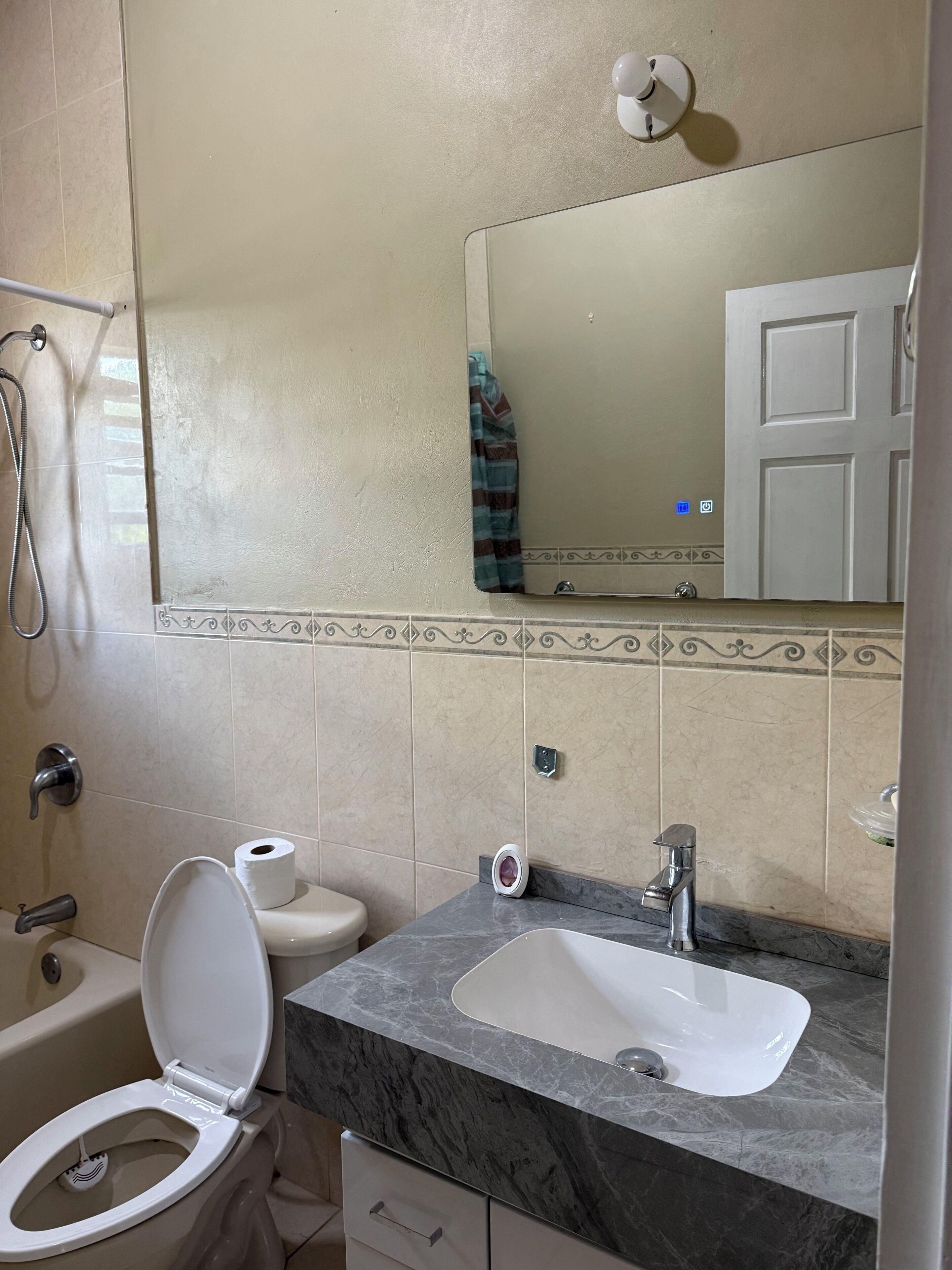 Ein Badezimmer mit Toilette, Waschbecken und Dusche.