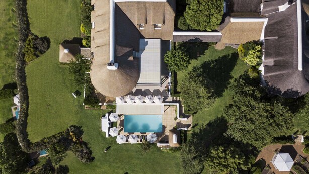 An aerial view of a property with a swimming pool, lounge area, and landscaped garden. - Chardonnay Room 1 with Manor Views 1044 (Western Cape)