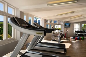 A gym with treadmills, a stationary bike, and a rack of dumbbells. - Chardonnay Room 1 with Manor Views 1044 (Western Cape)