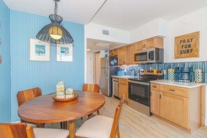 A compact kitchen with wooden cabinets, a microwave, and a coffee maker. - Luxurious Coastal Oceanfront Suite! Yachtsman 601 (Myrtle Beach)