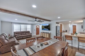 A spacious living area with a sofa set, a dining table, and a kitchen area with a refrigerator. - 25 minutes from Clemson, newly remodeled home! (Seneca)