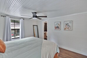 A bedroom with a bed, a ceiling fan, a window with curtains, and two wall-mounted artworks. - 25 minutes from Clemson, newly remodeled home! (Seneca)