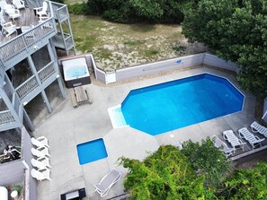 A backyard with a swimming pool, lounge chairs, a hot tub, and a deck with chairs. - Oceanside, close to beach, Priv. Pool, Hot Tub, Dogs Welcome-  WW1033, Driftwood I (Corolla)