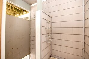 A corner bathroom with a shower, a metal towel rack, and a wooden floor. - Oceanside, close to beach, Priv. Pool, Hot Tub, Dogs Welcome-  WW1033, Driftwood I (Corolla)