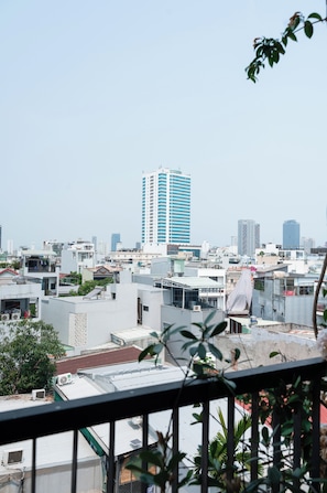 A cityscape with high-rise buildings, including a prominent blue and white skyscraper. - Green Apartment near My Khe Beach and Dragon Bridge -R302 (Đà Nẵng)