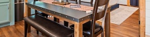 A dining table with benches, a rug, and a patterned placemat. - NEW! Pool, Hot Tub, Pickleball, Rope Course, EV (Broken Bow)
