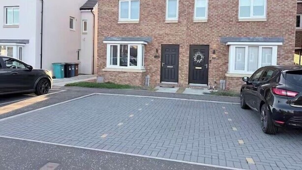 A residential building with a brick facade, a front door, and a driveway with two cars parked. - 3-Bed House, Sleeps 7 with Parking & Garden (Wishaw)