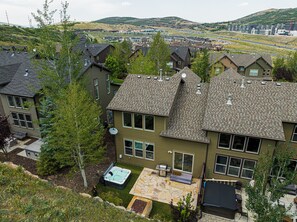 A residential area with houses, a swimming pool, and a patio area.