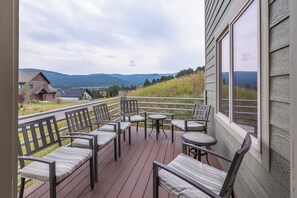 A deck with outdoor seating and a view of a hilly landscape. - New Listing! | Private Hot Tub & Minutes to Big Sky Resort and Town Center (Big Sky)