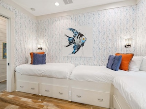 A bedroom with two beds, a wall-mounted artwork, and bedside lamps. - SOUTH of 30A in WaterColor on Park Row! Loaded! (Santa Rosa Beach)