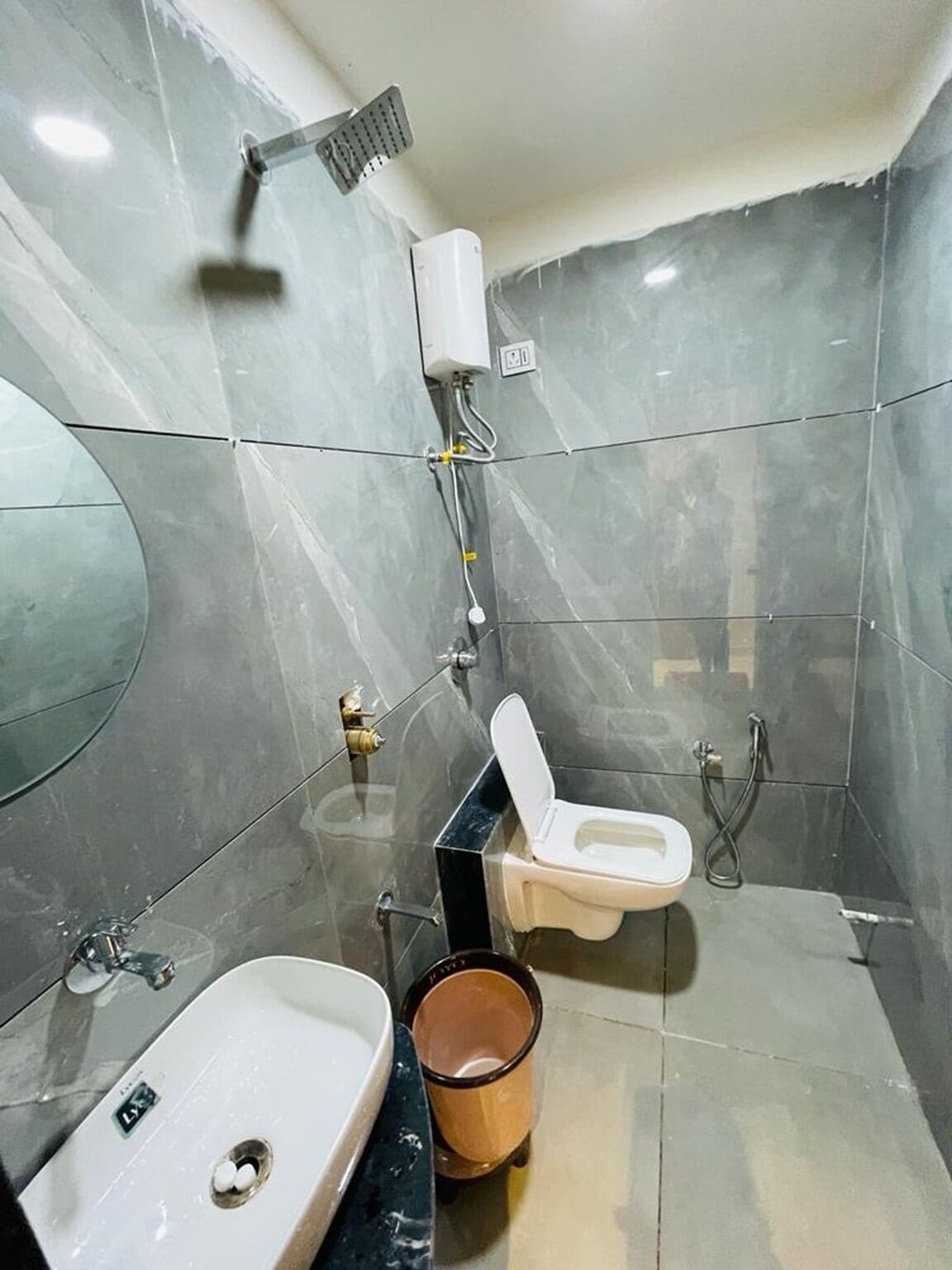 A bathroom with a toilet, sink, and shower.