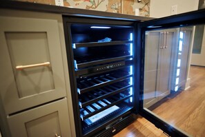 A modern kitchen with built-in appliances, including a refrigerator with a digital display. - Charming 4-bedroom MidCentury Bungalow—Brand New! (Oxford)