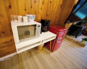 A kitchen with a microwave, coffee maker, and a red refrigerator. - The Westside Hideaway with Hot Tub and Patio (Minneapolis)