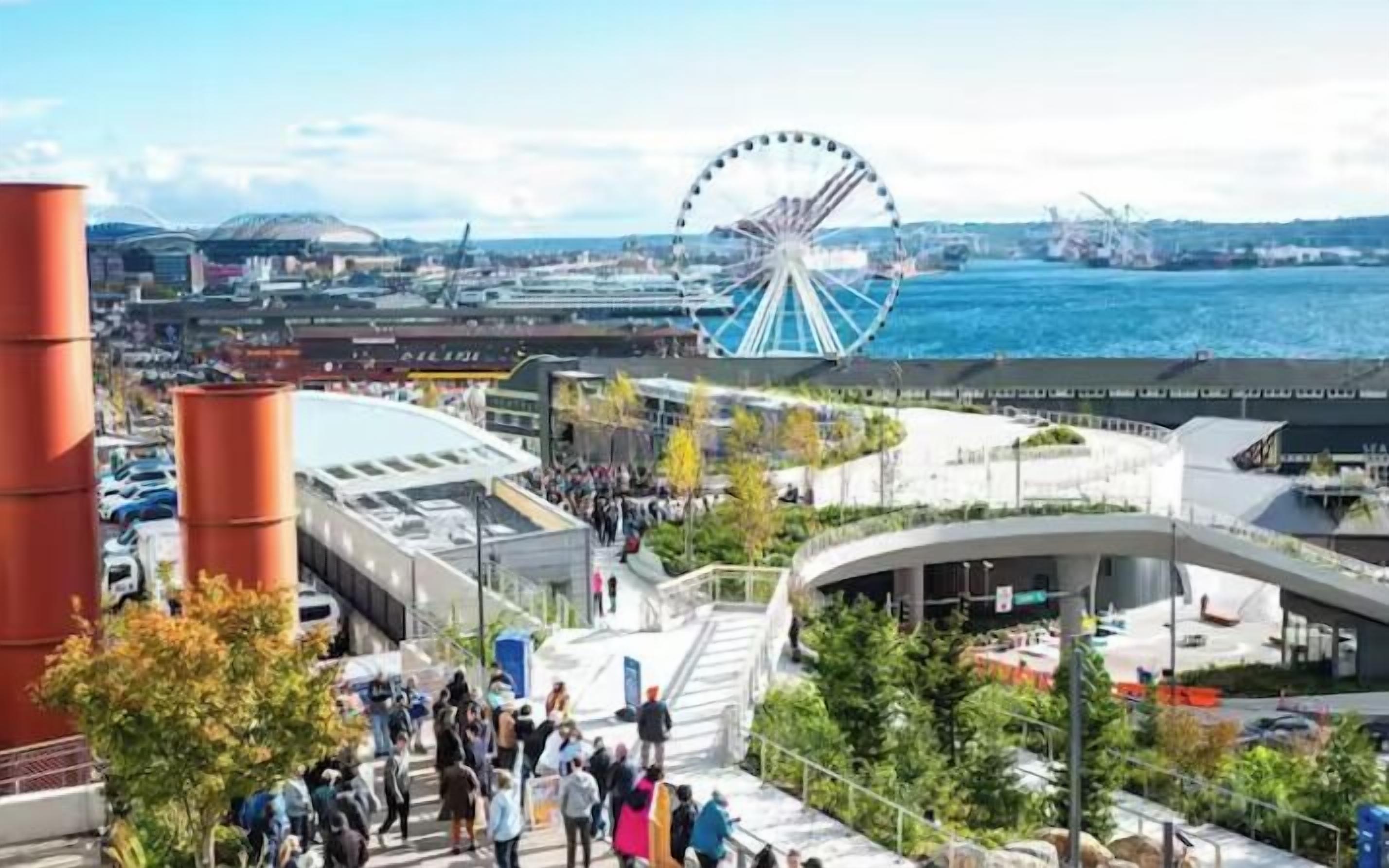 A waterfront view with a Ferris wheel, modern buildings, and a crowd of people.