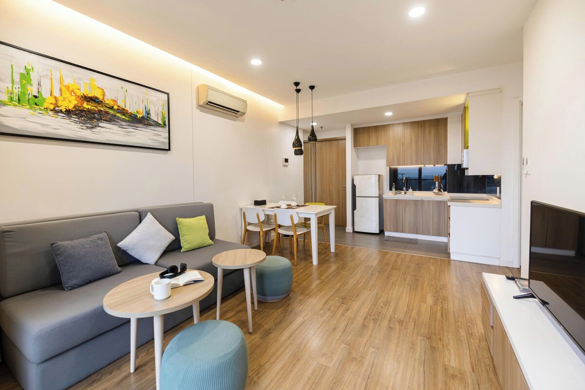 A modern apartment with a living area, dining space, and kitchen.