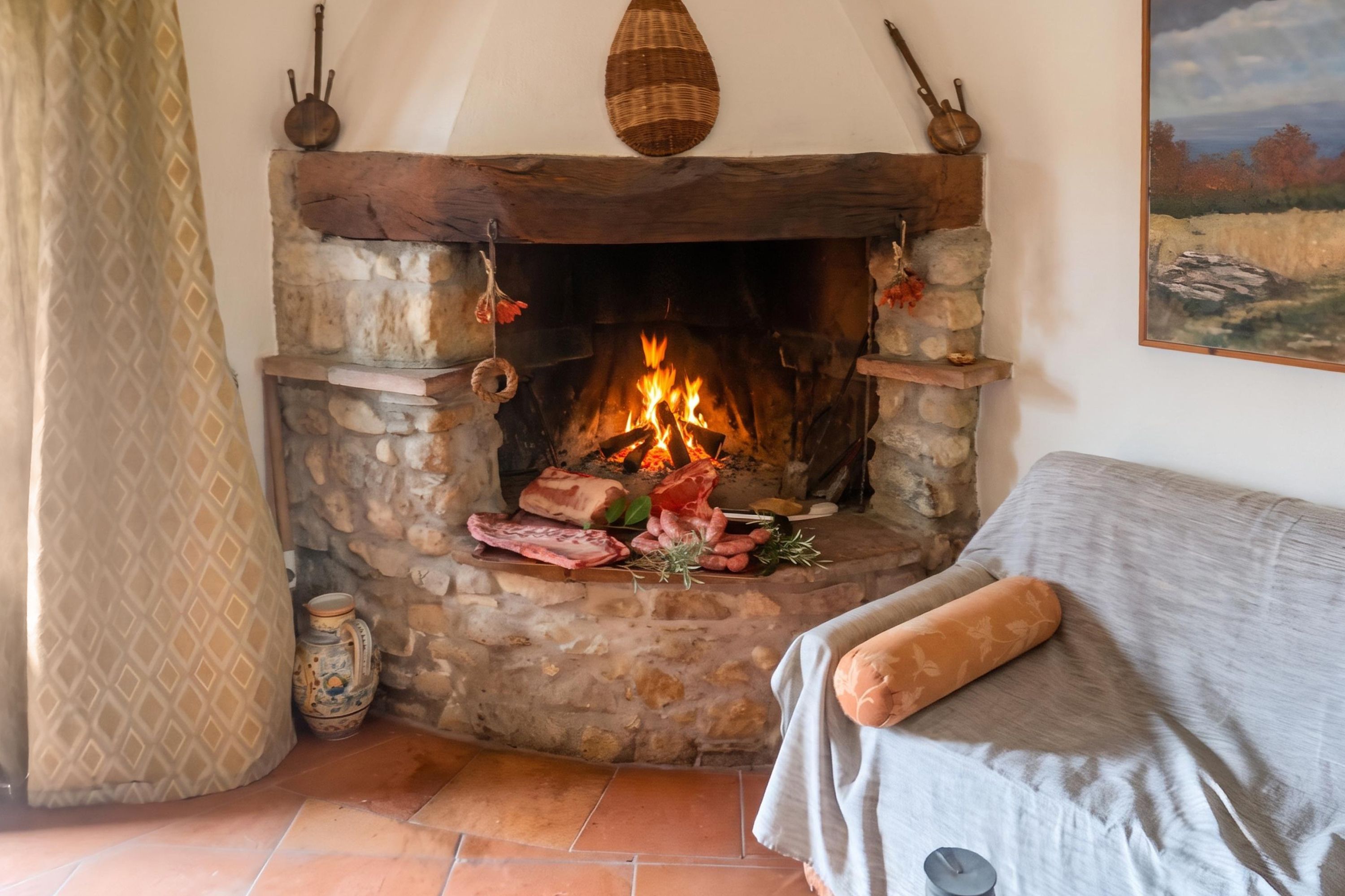 A stone fireplace with a fire, a rustic wooden mantel, and a patterned curtain.